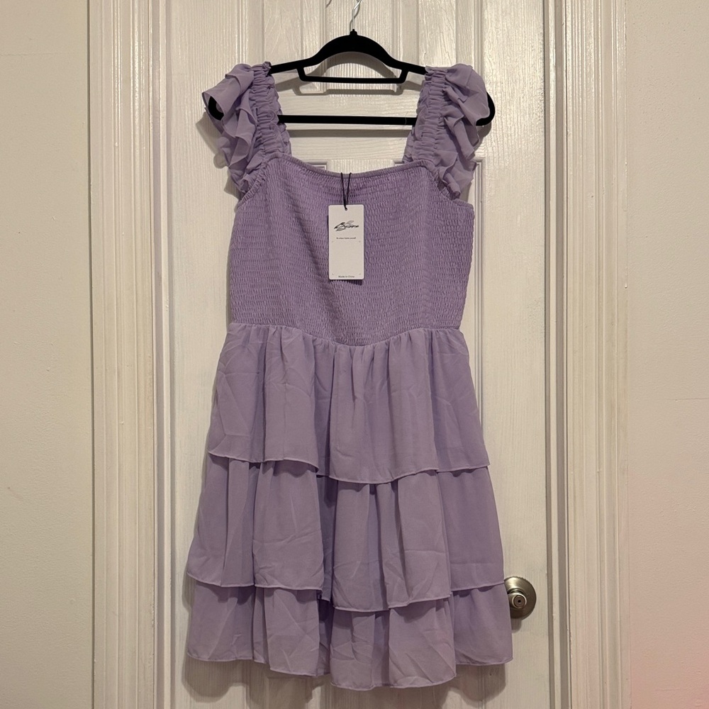 Purple tiered dress with smocking in the bodice and ruffle sleeves